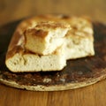 Fresh Italian focaccia bread with broken piece on top Royalty Free Stock Photo