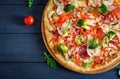 Fresh italian pizza with chicken fillet, mushrooms, ham, salami, tomatoes Royalty Free Stock Photo
