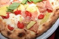 Fresh italian Pizza with Ham, Pineapple, Tomato, Basil and Cheese Royalty Free Stock Photo