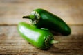 Fresh jalapeno peppers on a dark wood background