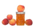 Fresh jar of peach jam with fruit around it isolated Royalty Free Stock Photo