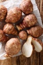 Fresh Jerusalem artichoke root close-up. Vertical top view