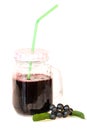 Fresh juice of chokeberry or Aronia melanocarpa in glass with straw and berry and leaves near, isolated on white background.