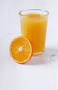 Fresh juice in a glass with an orange half Royalty Free Stock Photo