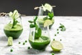 Fresh Juice Smoothie Made with Organic Greens and Limes, Detox smoothie, green fresh peas, cucumber, spinach and lime Royalty Free Stock Photo