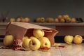 Fresh juicy apples in in paper bag and cinnamon sticks Royalty Free Stock Photo