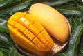 Fresh juicy beautiful diced mango fruit in bamboo basket on green leaves background, top view, close up, macro, copy space. Royalty Free Stock Photo