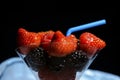 Fresh juicy berries, strawberries, raspberries, blackberries in a glass cocktail glass with a cocktail straw. Royalty Free Stock Photo