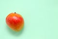 Fresh juicy bright exotic mango fruit on a gentle mint light background with place for text. healthy eating and healthy Royalty Free Stock Photo