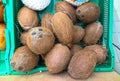 Fresh juicy delicious coconuts on the supermarket counter