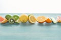 Fresh juicy fruits and cucumber on blue textured surface. Royalty Free Stock Photo