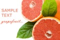 Fresh juicy grapefruits with green leafs