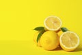 Fresh juicy lemon slides on a bright yellow background. Concept minimalism. Horizontal frame. Copy space.