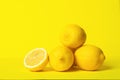 Fresh juicy lemon slides on a bright yellow background. Concept minimalism. Horizontal frame. Copy space.