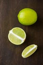 Fresh juicy limes on dark wooden background Royalty Free Stock Photo