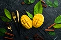 Fresh juicy mango cut into pieces with utensils. Royalty Free Stock Photo