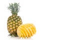 Fresh juicy nutritious cut pineapple with whole fruit as backgro Royalty Free Stock Photo