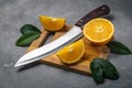 Fresh juicy orange. Slice thin slices on a cutting board.