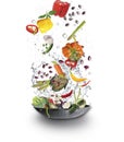 Fresh Juicy organic vegetables falling into cooking pot with water splash. Veggy concept