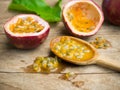 Fresh juicy passion fruit in wooden spoon.