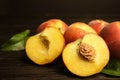 Fresh juicy peaches and leaves on wooden table Royalty Free Stock Photo