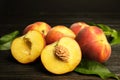 Fresh juicy peaches and leaves on wooden table Royalty Free Stock Photo