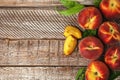 Fresh juicy peaches and leaves on wooden table, flat lay Royalty Free Stock Photo