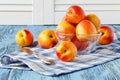 Fresh juicy peaches on napkin and turquoise wooden background Royalty Free Stock Photo