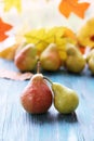 Fresh juicy pears, autumn leaves, on a wooden table Royalty Free Stock Photo