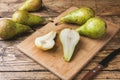 Fresh juicy Pears Conference whole and cut by slides on wooden rustic background Royalty Free Stock Photo