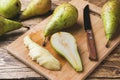 Fresh juicy Pears Conference whole and cut by slides on wooden rustic background Royalty Free Stock Photo