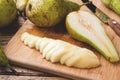 Fresh juicy Pears Conference whole and cut by slides on wooden rustic background Royalty Free Stock Photo