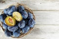 Fresh juicy plums in wooden basket, healthy autumn fruits Royalty Free Stock Photo