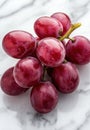 Fresh and juicy red grapes on a marble surface Royalty Free Stock Photo
