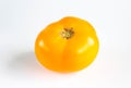 Fresh ripe yellow tomato on a white background
