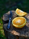 Fresh juicy slices of an orange and an old vintage knife