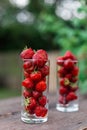 Fresh juicy strawberries in a glass on a wooden table in the garden. Natural Strawberry Juice Concept Royalty Free Stock Photo