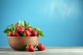 Fresh juicy strawberries in wood bowl on light blue table