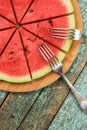 Fresh juicy watermelon as vegan pizza with two forks on shabby g Royalty Free Stock Photo