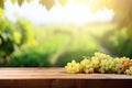 Fresh juicy white vine grapes on rustic wooden table with blurred vineyard background