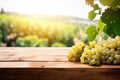 Fresh juicy white vine grapes on rustic wooden table with blurred vineyard background