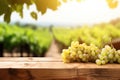 Fresh juicy white vine grapes on rustic wooden table with blurred vineyard background