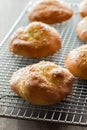 Fresh keto buns on a cooling rack with bright sunlight in behind.