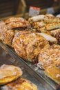 Fresh khachapuri and sausages in dough on counter. Street food, tasty snack for lunch, delicious cheese stuffed buns Royalty Free Stock Photo