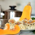 Fresh Khinkali or meat dumplings plate. Cut pumpkin and kitchen utensils on blurred background. Food concept. Square Royalty Free Stock Photo