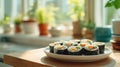 Fresh kimbap rolls with colorful vegetables on white rectangular plate in bright minimalist kitchen with natural Royalty Free Stock Photo