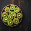 Fresh kiwi fruit arranged on rustic wooden background, juicy slices Royalty Free Stock Photo