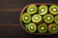 Fresh kiwi fruit arranged on rustic wooden background, juicy slices Royalty Free Stock Photo