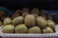 Fresh kiwi fruit in basket on display at market. Fresh fruit brown juicy kiwi fruits. Stacked group of kiwifruits, Organic kiwi or Royalty Free Stock Photo