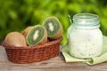 Fresh kiwi fruit in a basket on a wooden table Royalty Free Stock Photo